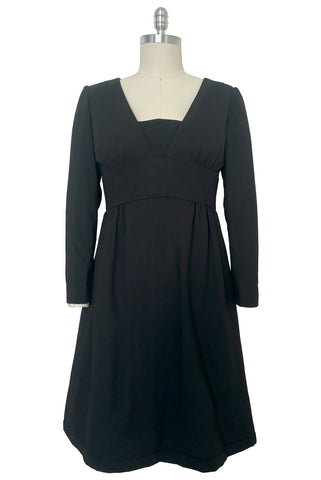 Front view of 1960s vintage Mod crepe empire waist little black dress, by Teal Traina, size small to medium.