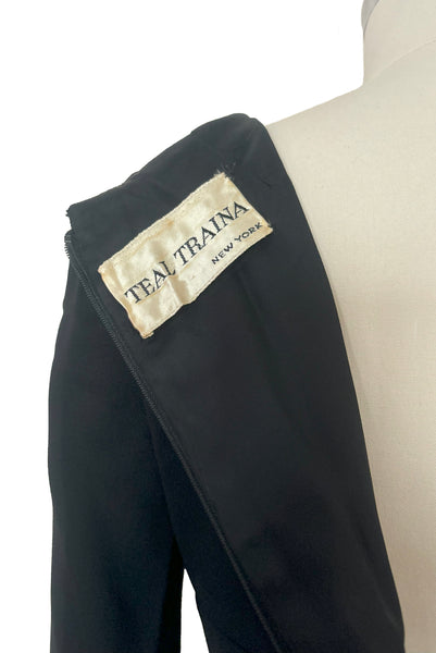 Interior detail view of 1960s vintage Mod crepe empire waist little black dress, by Teal Traina, size small to medium. Showing the Teal Traina label.