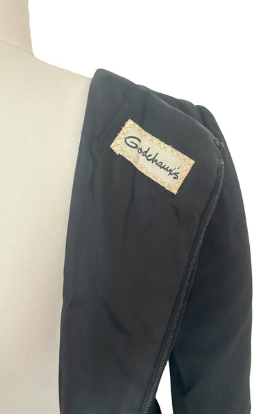 Interior detail view of 1960s vintage Mod crepe empire waist little black dress, by Teal Traina, size small to medium. Showing the Godchaux's label.