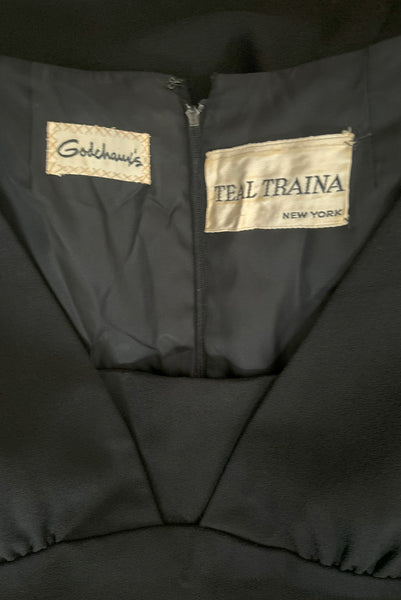 Interior detail view of 1960s vintage Mod crepe empire waist little black dress, by Teal Traina, size small to medium. Showing the Godchaux's and Teal Traina labels.