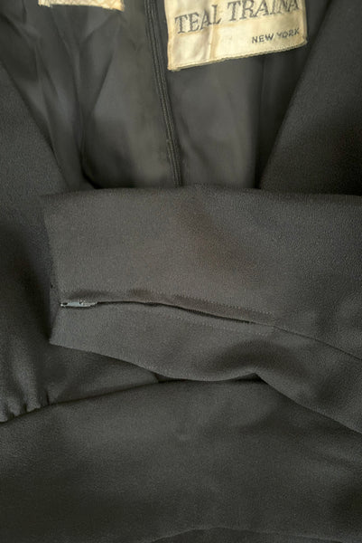 Detail view of 1960s vintage Mod crepe empire waist little black dress, by Teal Traina, size small to medium. Showing the zippers a the cuffs.