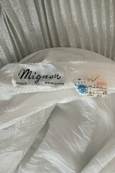 Interior detail view of 1960s silver Lurex and white beaded evening gown by Mignon, medium to large. Showing the label and tags.