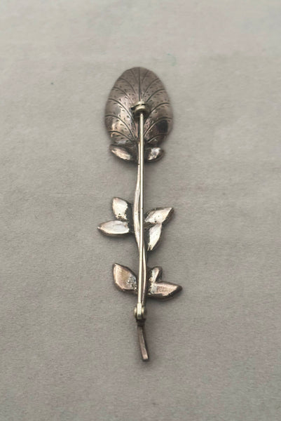 Vertical back view of 1950s vintage silver floral spoon shaped botanical brooch.