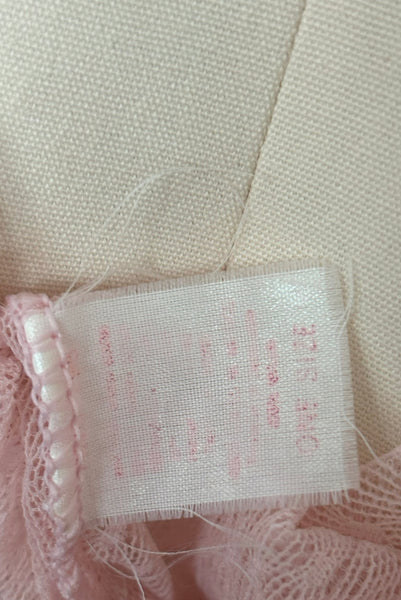 Detail view of 1990s vintage pale pink mesh tie pajama top and pants lingerie set, size small, medium, large. Showing the one size faded tag.