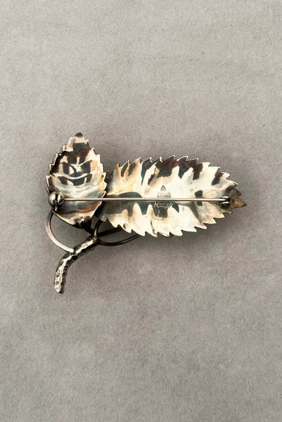 Vertical back view of 1950s vintage Gertrud Engel 925 sterling silver Danish modernist leaf and berry botanical brooch for Anton Michelsen, made in Denmark.