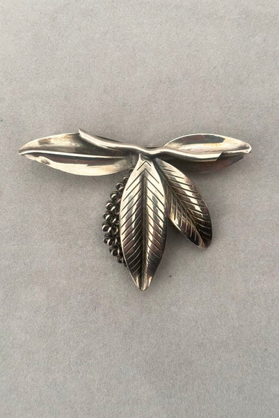 Vertical front view of 1950s vintage Gertrud Engel 925 sterling silver Danish modernist botanical leaf brooch for Anton Michelsen, made in Denmark.