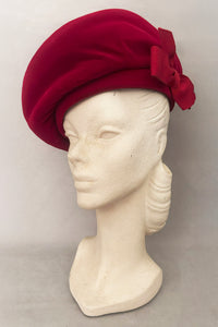 Vertical 3/4 view of 1950s vintage dark pink velvet oversized beret hat, by Evelyn Varon.