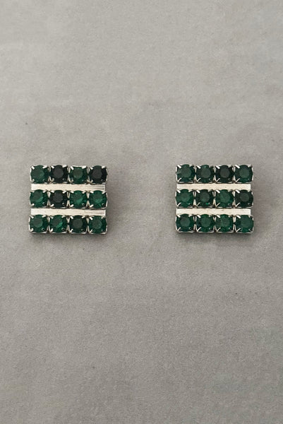 Vertical front view of 1960s vintage large rectangular silver tone and round emerald green rhinestone clip-on earrings.