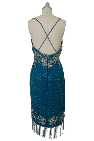 Back view of 1980s vintage sweetheart neckline turquoise blue asymmetrical fringed beaded cocktail dress, size small to medium.