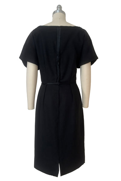Back view of 1950s vintage black imported linen satin and bow trimmed sheath dress, size small to medium.