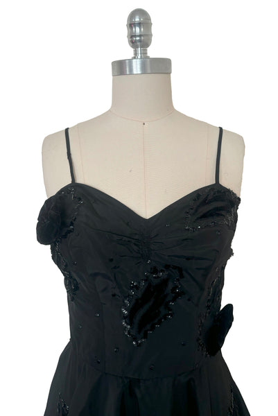 Bodice front view of 1950s vintage black taffeta sequin applique cocktail dress embellished with black velvet roses, size extra extra small to extra small.