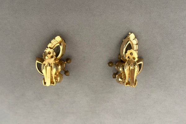 Horizontal back view of 1950s vintage gray and iridescent rhinestone gold tone clip-on earrings.