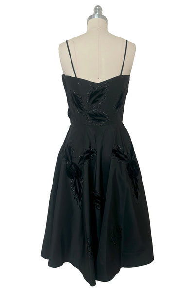 Back view of 1950s vintage black taffeta sequin applique cocktail dress embellished with black velvet roses, size extra extra small to extra small.