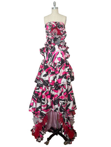 Front view of 2000s y2k vintage pink, black, white, and red psychedelic satin strapless ruffled prom or quinceañera gown with train, extra small to small.