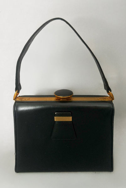 Vertical front view of 1930s vintage Art Deco black leather gold frame handbag by Evans with coin purse, mirror, comb, and lipstick holder.