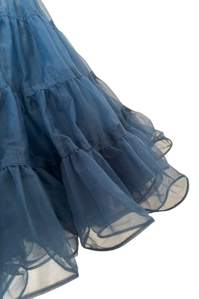 Detail view of 1970s vintage dark blue nylon adjustable petticoat by Malco Modes, small, medium, large. Showing the tiered, ruffled hem.