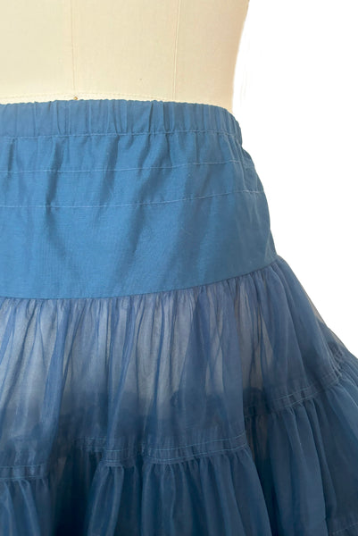 Detail view of 1970s vintage dark blue nylon adjustable petticoat by Malco Modes, small, medium, large. Showing the elastic waist and opaque yoke.