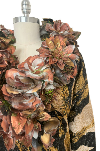 Detail view of 1960s vintage metallic black, gold, and white lurex fancy dress costume with copper painted silk flower collar, size medium to large. Showing a close up of the copper painted flowers.