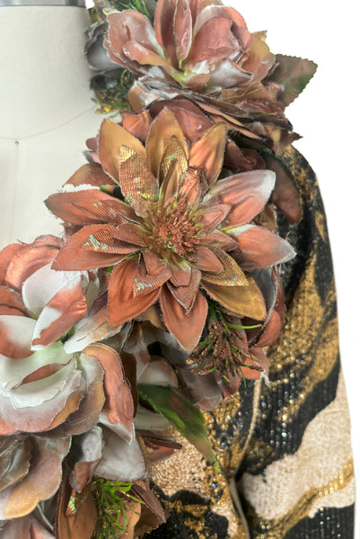 Detail view of 1960s vintage metallic black, gold, and white lurex fancy dress costume with copper painted silk flower collar, size medium to large. Showing a close up of the copper painted flowers.