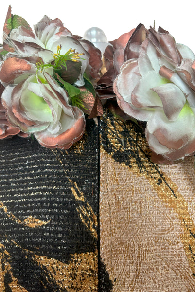 Detail view of 1960s vintage metallic black, gold, and white lurex fancy dress costume with copper painted silk flower collar, size medium to large. Showing a close up of the copper painted flowers.