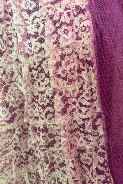 Detail view of as is 1950s vintage purple tulle and cream lace strapless ruffled evening dress, size extra small to small. Showing purple bleed on the cream lace.