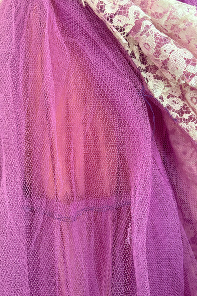 Detail view of as is 1950s vintage purple tulle and cream lace strapless ruffled evening dress, size extra small to small. Showing breaks in the purple tulle.