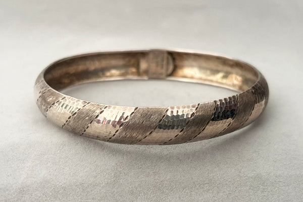 Horizontal front view of 1970s vintage stripe engraved Italian 925 sterling silver bangle bracelet made in Salerno, Italy.