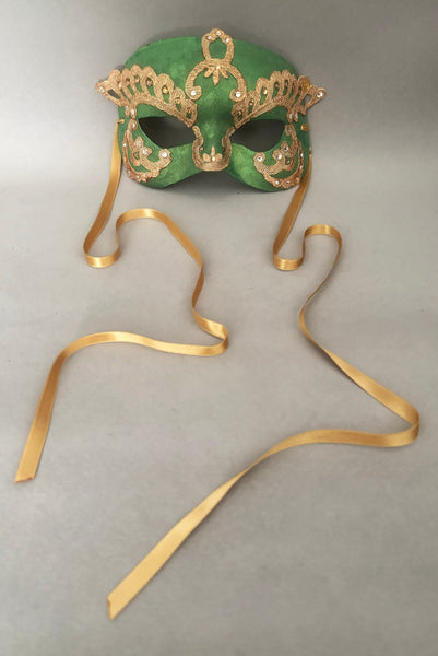Vertical front view of 1990s gold Lurex lace, gold Swarovski crystal, and metallic green painted half mask with gold satin ribbon ties. Showing the gold satin ribbon ties.