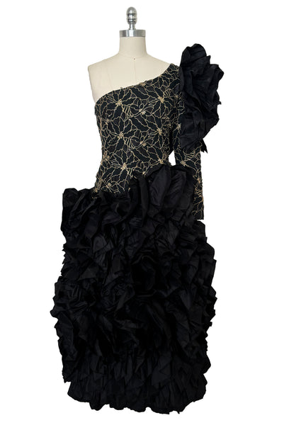 Front view of 1980s vintage black & gold floral embroidered one shoulder ruffled silk evening dress, size extra small to small.