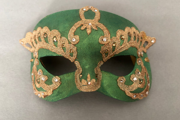 Horizontal flat view of 1990s gold Lurex lace, gold Swarovski crystal, and metallic green painted half mask with gold satin ribbon ties.