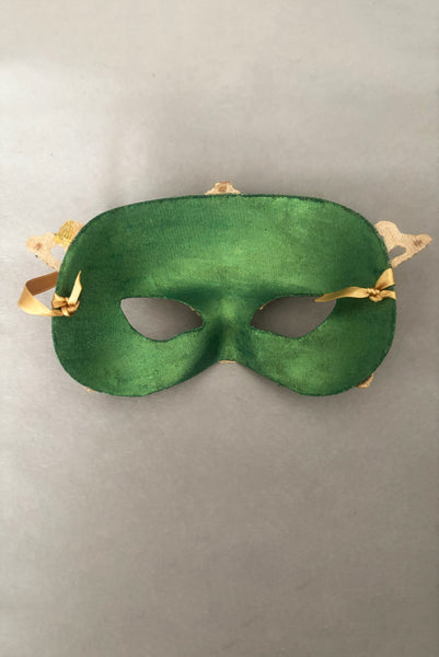Vertical back view of 1990s gold Lurex lace, gold Swarovski crystal, and metallic green painted half mask with gold satin ribbon ties. Showing the inside of the mask.