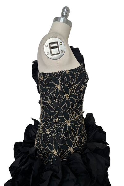 Bodice side view of 1980s vintage black & gold floral embroidered one shoulder ruffled silk evening dress, size extra small to small. Showing the gold floral embroidered bodice with dropped waist.