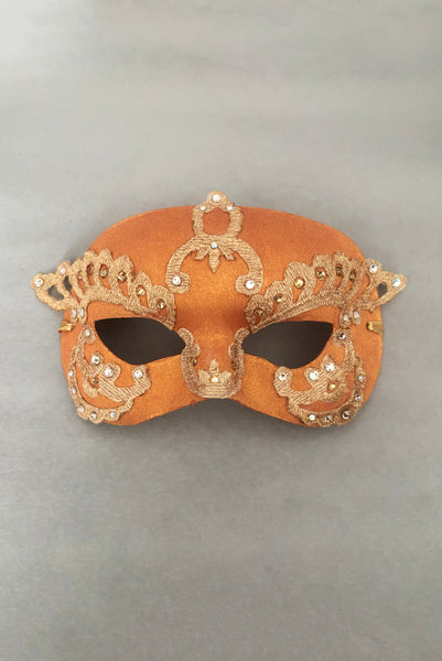 Vertical flat view of 1990s gold Lurex lace, gold Swarovski crystal, and metallic pink rose gold painted half mask with gold satin ribbon ties.