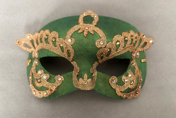 Horizontal flat view of 1990s gold Lurex lace, gold Swarovski crystal, and metallic green painted half mask with gold satin ribbon ties.