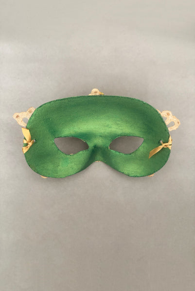 Vertical back view of 1990s gold Lurex lace, gold Swarovski crystal, and metallic green painted half mask with gold satin ribbon ties. Showing the inside of the mask.
