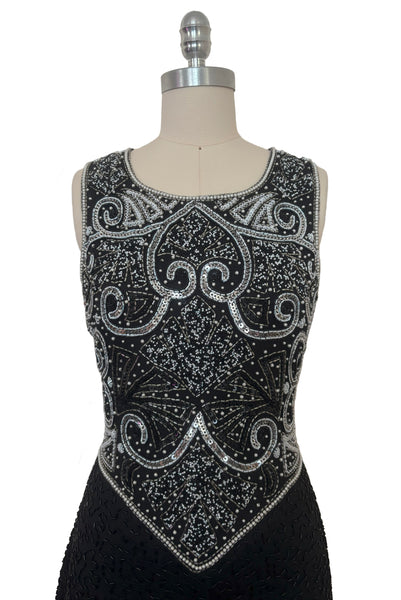 Bodice front view of 1980s vintage Art Deco faux pearl, silver and black glass beaded black silk chiffon evening dress, size small to medium. With a scoop neckline, sleeveless bodice, and floor length pencil skirt.