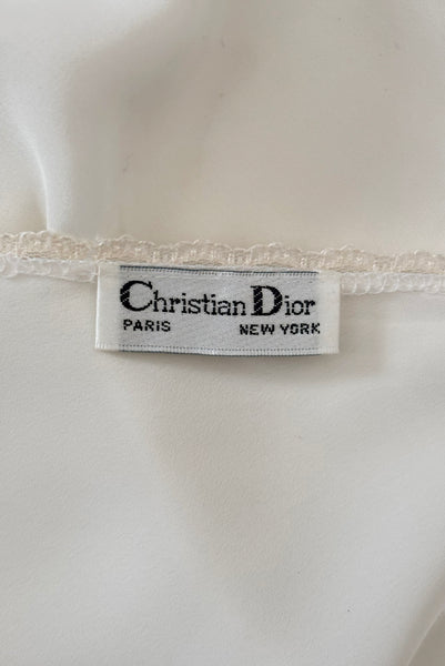 Interior detail view of 1970s vintage white polyester challis and floral lace faux pearl embellished lingerie camisole top by Christian Dior, size small to medium.  Showing the Christian Dior label.