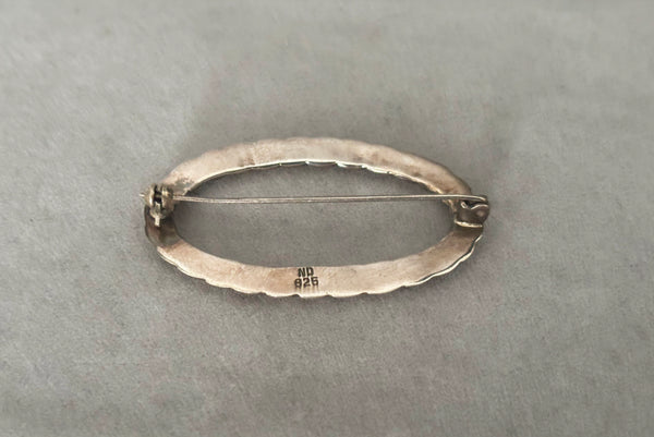 Horizontal back perspective view of 1980s vintage 925 sterling silver twisted rope design oval brooch/pin by Nida Factory. Showing the ND 925 stamp.