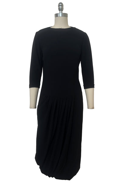 Front view of 1940s vintage black wool crew neck, 3/4 sleeve, drop waist dress with asymmetrical gathered front draped wrap skirt, size extra small to small.