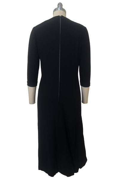 Back view of 1940s vintage black wool crew neck, 3/4 sleeve, drop waist dress with asymmetrical gathered front draped wrap skirt, size extra small to small. Showing the long metal zipper.