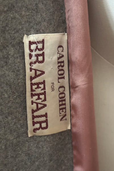 Interior detail view of 1960s vintage heavy gray and rust tie waist wool coat by Carol Cohen for Braefair, size medium to large. Showing the Carol Cohen for Braefair label.