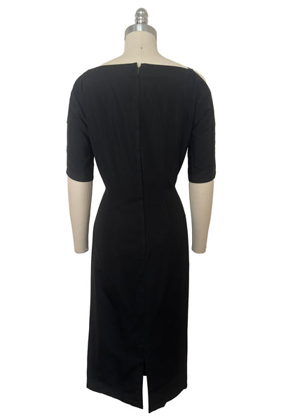 Back view of 1950s vintage black boat neck, raglan open sleeve wiggle dress, size small to medium.