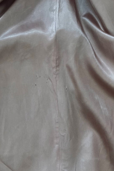 Interior detail view of 1960s vintage heavy gray and rust tie waist wool coat by Carol Cohen for Braefair, size medium to large. Showing the pink synthetic satin lining.