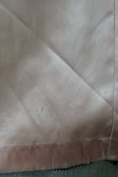 Interior detail view of 1960s vintage heavy gray and rust tie waist wool coat by Carol Cohen for Braefair, size medium to large. Showing minor damage to the pink satin lining near the hem.