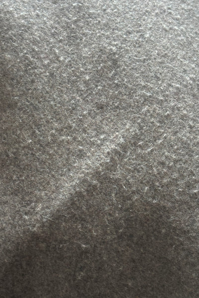Detail view of 1960s vintage heavy gray and rust tie waist wool coat by Carol Cohen for Braefair, size medium to large. Showing some fuzzing to the gray wool at the back seat.