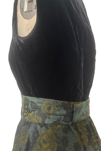 Detail view of 1950s vintage black velvet crew neck, sleeveless, green floral brocade pencil skirt cocktail dress, with beaded belt, size medium to large. Showing the belt wrapping around the back and closing with hooks.
