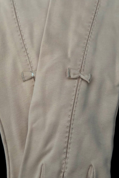 Detail view of 1950s vintage Below elbow pointed cuff beige Sea Island cotton gloves, by Christian Dior, size 7.5. Showing the handstitched pleated detail at the center front and tiny bow embellishment.