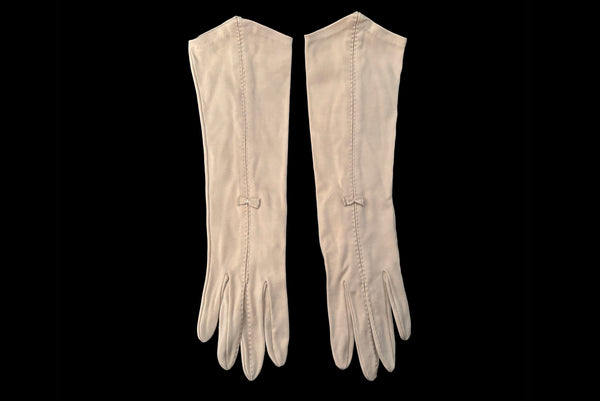 Horizontal front view of 1950s vintage Below elbow pointed cuff beige Sea Island cotton gloves, by Christian Dior, size 7.5.