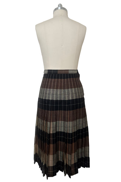 Back view of 1970s vintage reversible black, tan, cream, and green wool plaid pleated midi skirt by Charlotte Ford for Classique Collection, size medium to large. Showing the darker side.