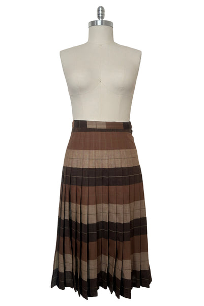 Front view of 1970s vintage reversible black, tan, cream, and green wool plaid pleated midi skirt by Charlotte Ford for Classique Collection, size medium to large. Showing the lighter side.